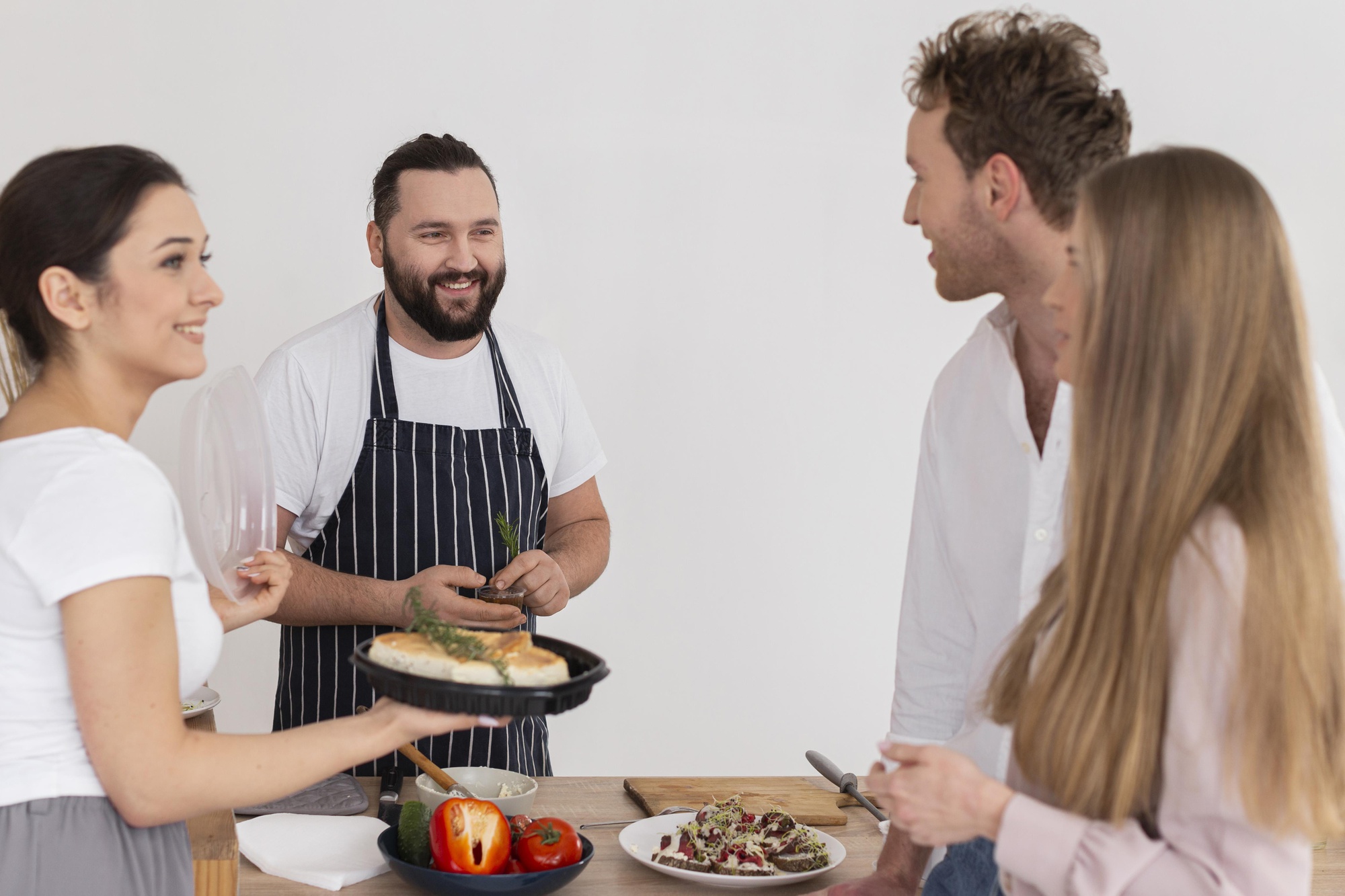 Chef speaking with clients in a warm studio